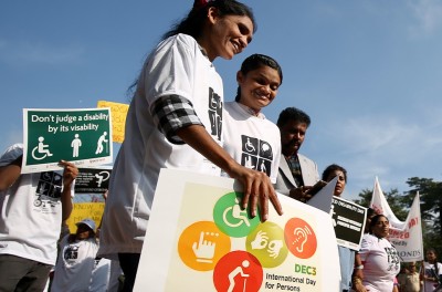 Des personnes handicapées tiennent des pancartes lors de la Journée internationale des personnes handicapées à Bangalore, en Inde. © EPA